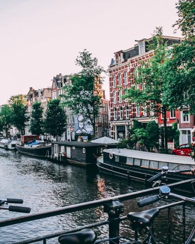 Classic Amsterdam canal view with traditional Dutch houses and boats