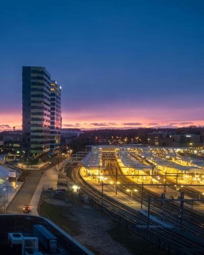 Explore the illuminated Arnhem Central Station at sunset, showcasing urban architecture in the Netherlands.