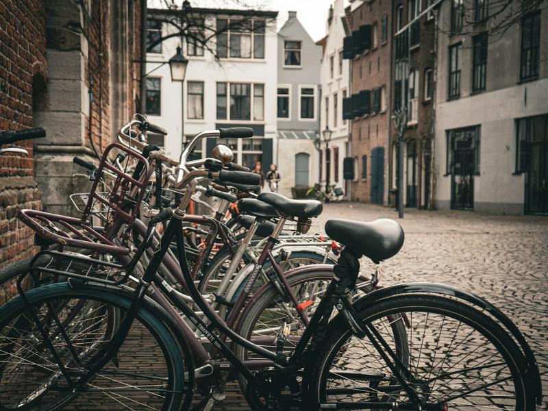 Row of bicycles parked along a cobbled street lined with brick buildings in Utrecht, Netherlands