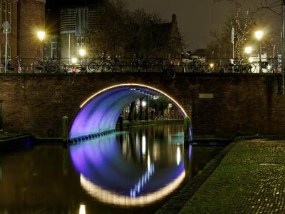 Illuminated canal bridge in Utrecht at night