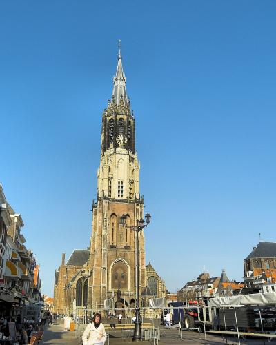 The Markt and the Nieuwe Kerk tower in Delft under a blue sky