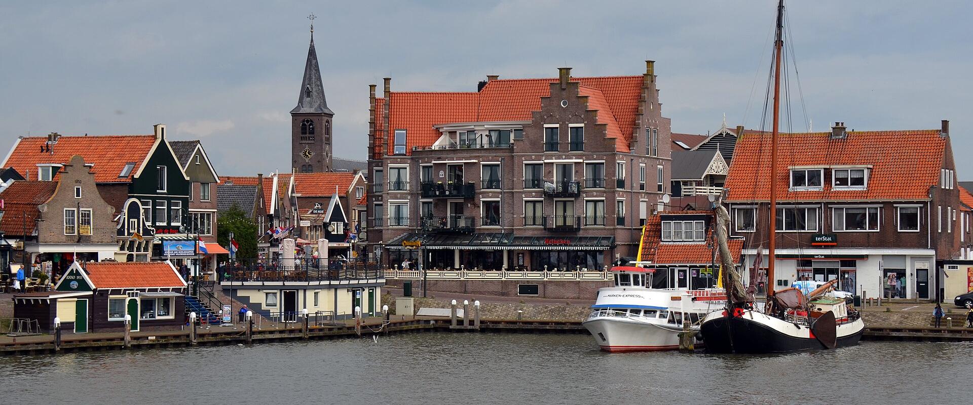 The harbour front of Volendam with its church tower and traditional houses