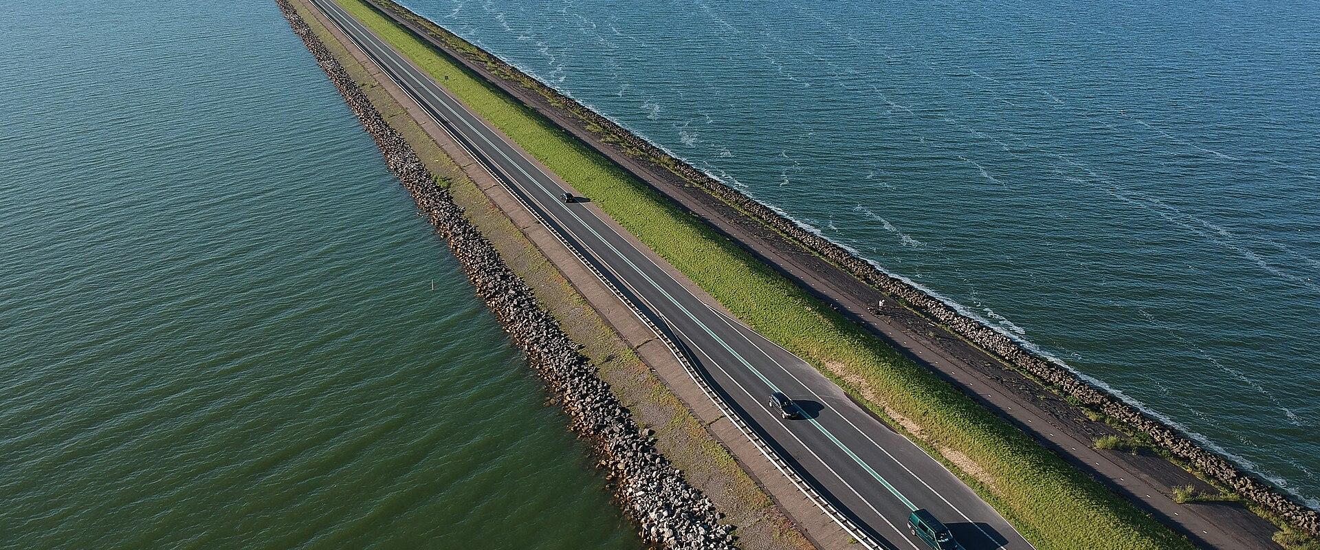 A long dike road running straight across the water of the Markermeer