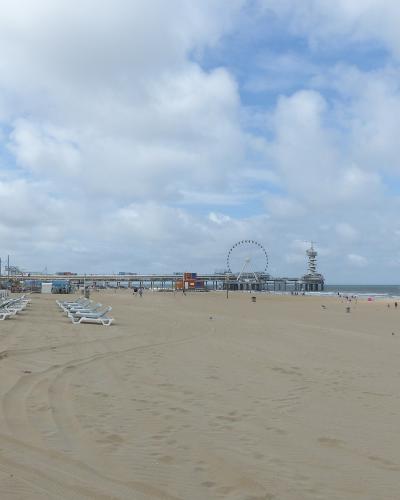 The wide Noorderstrand beach at Scheveningen with the pier and Ferris wheel