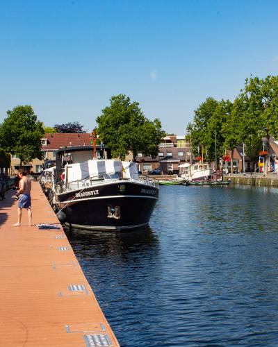 Moored boats along the quay of the Piushaven in Tilburg in summer