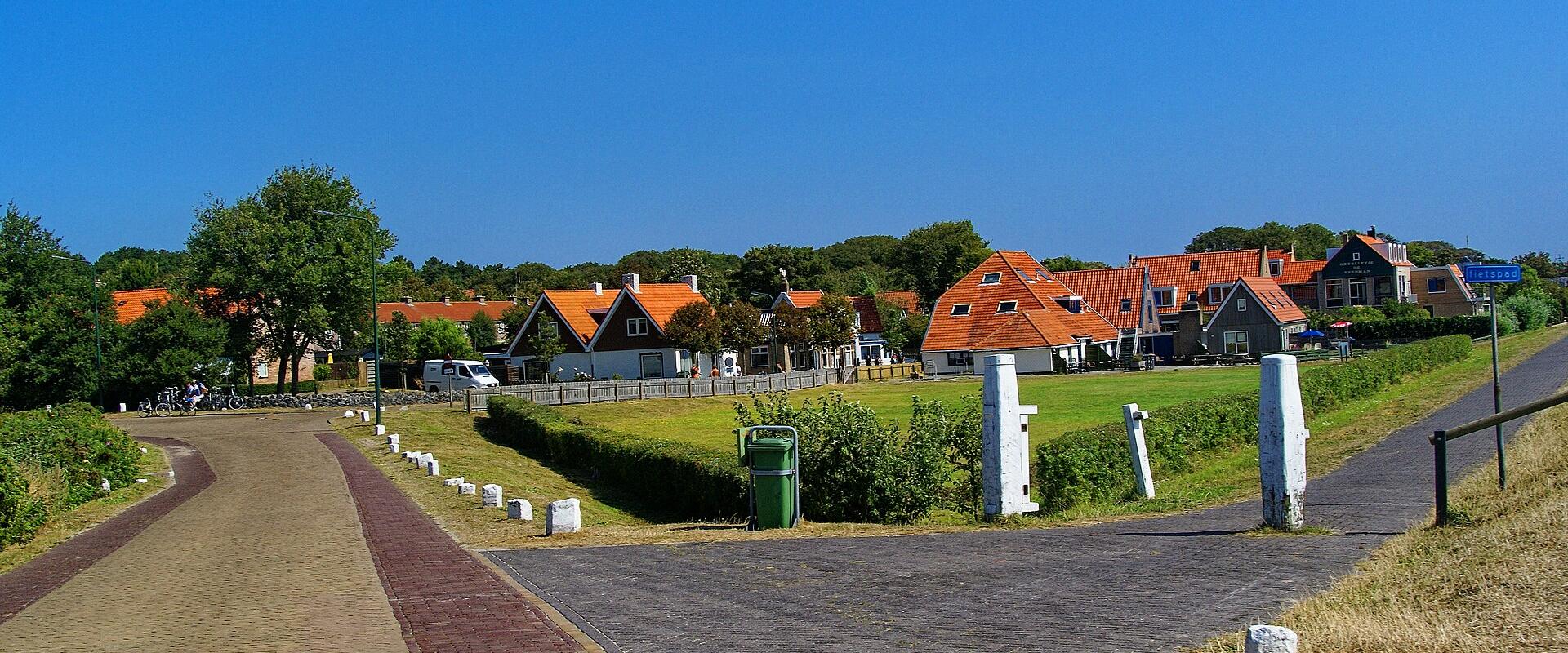 Road leading into the village on Vlieland past dunes and grassland