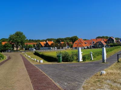 Road leading into the village on Vlieland past dunes and grassland