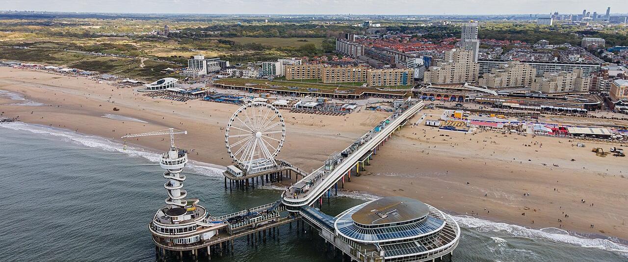 Aerial view of the Scheveningen pier, Ferris wheel and wide sandy beach on the North Sea