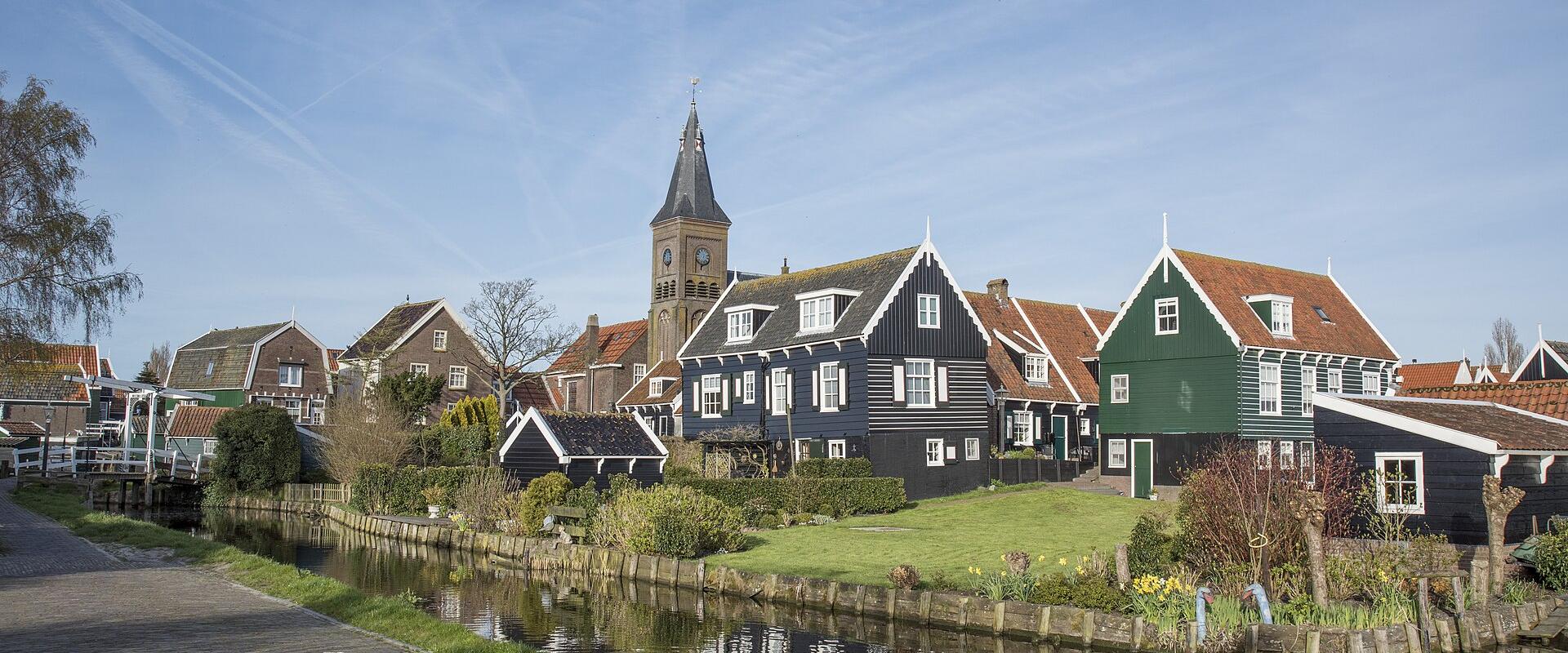 Green wooden houses and the church of Marken village