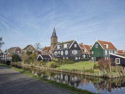 Green wooden houses and the church of Marken village